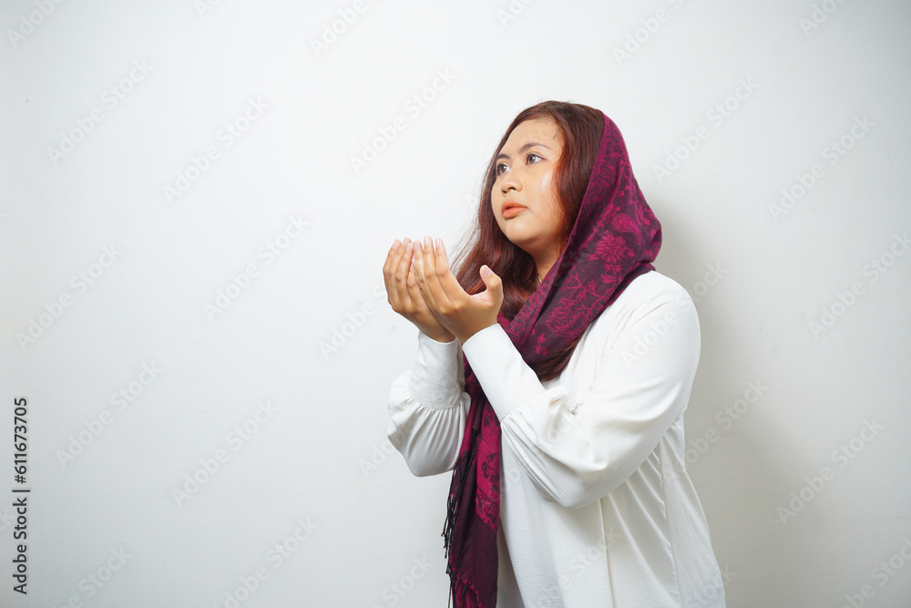 Religious beautiful Asian Muslim girl wearing a headscarf praying to God. Religious beautiful Asian Muslim girl wearing a headscarf praying to God.