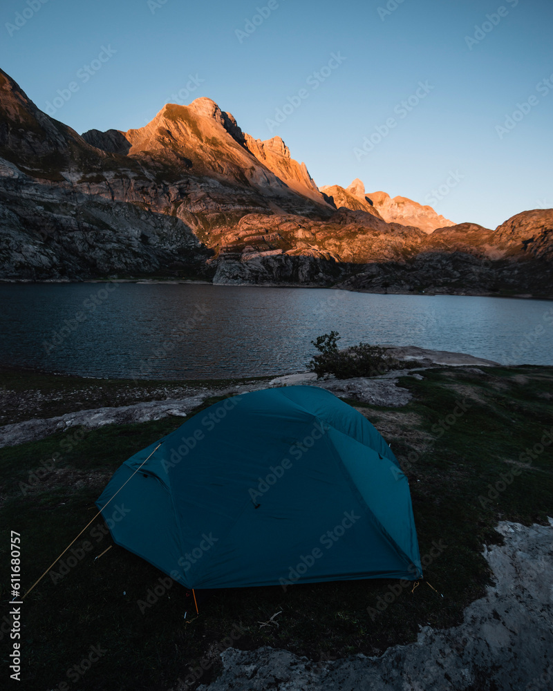 Tent in the ibon de estanes at dawn during a camping in the pyrenees