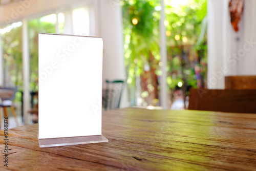 Mock up Menu frame standing on wood table in Bar restaurant cafe. space for text