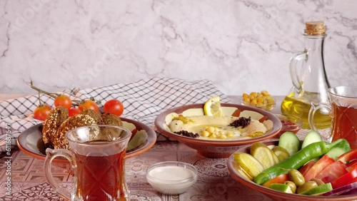 serving tea with traditional middle eastern breakfast with hummus and falafel - 4K 60 High quality colors