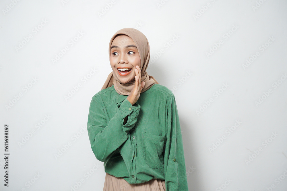 Cheerful young beautiful Asian Muslim woman shouting loud at copy space Cheerful young beautiful Asian Muslim woman shouting loud at copy space