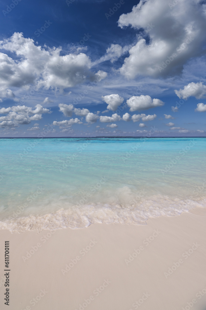 Sunny closeup of sea sand beach blue summer sky. Panoramic beach landscape. Tranquil relaxing sunshine soft waves splashing on Mediterranean sandy shore. Coastline seaside idyllic nature background Sunny closeup of sea sand beach blue summer sky. Panoramic beach landscape. Tranquil relaxing sunshine soft waves splashing on Mediterranean sandy shore. Coastline seaside idyllic nature background
