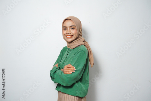 Beautiful young Asian woman in green casual smiling happy and looking confident