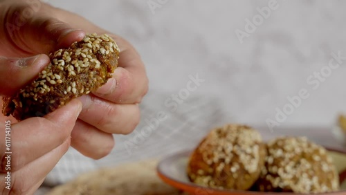 hand cutting falafel by hald and ready to dip