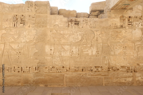 Inscriptions on the walls of the mortuary temple of Medinet Habu in Luxor in Egypt