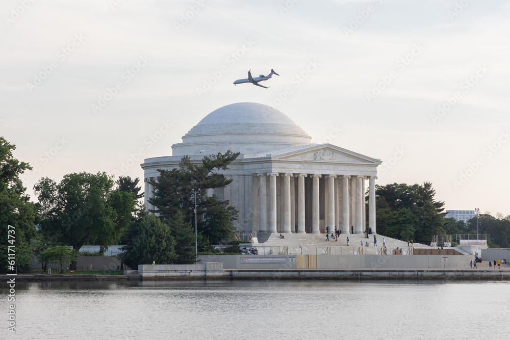 Airplane flying over the Jefferson Memorial