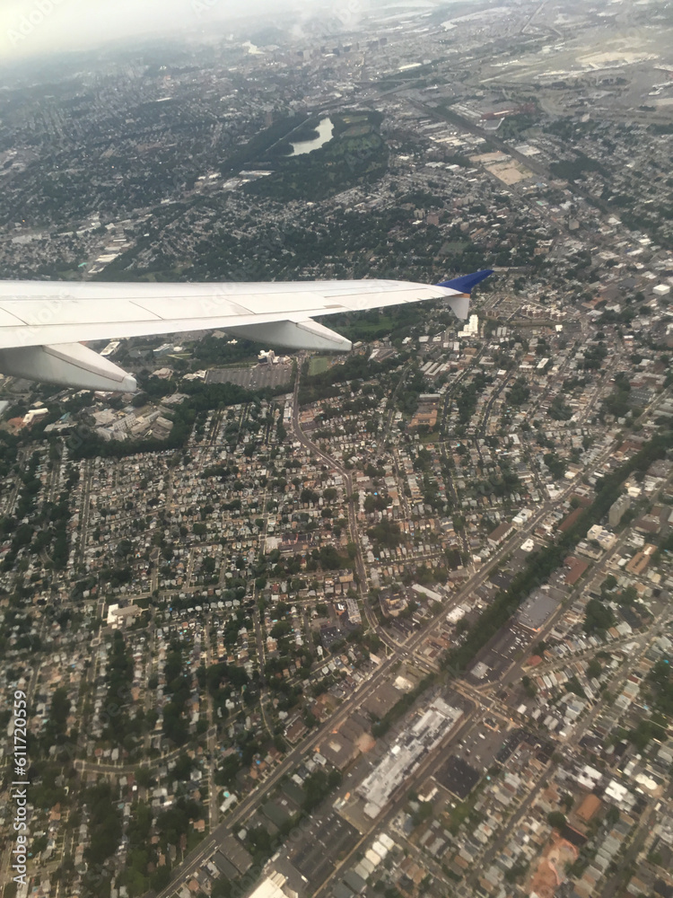 Flight leaving from a New York airport, looking down from plane on Queens, New York. View from airplane on NYC, aerial view of the city. View of Queens New York from an airplane. Flight leaving from a New York airport, looking down from plane on Queens, New York. View from airplane on NYC, aerial view of the city. View of Queens New York from an airplane.