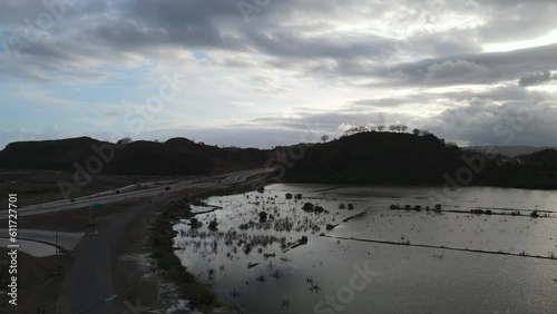 Drone spins around over new highway in remote part of Lombok, Indonesia near Tanjung Aan Beach and Gerupuk village photo