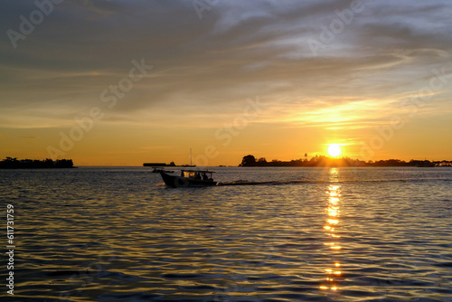 sunset view from the pier in makassar city, sunset at the sea, sunset over the sea, sunset in the sea © Fani