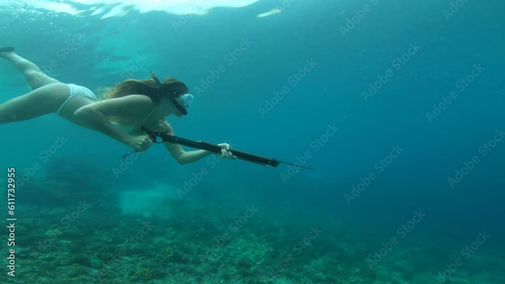 Snorkeling, spear gun and woman in ocean for fishing, hunting and catch fish on adventure, holiday and vacation. Diving, travel and female person in tropical water with harpoon swim for spearfishing Snorkeling, spear gun and woman in ocean for fishing, hunting and catch fish on adventure, holiday and vacation. Diving, travel and female person in tropical water with harpoon swim for spearfishing