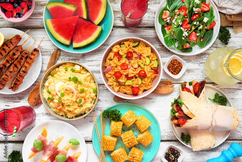 Wallpaper Mural Summer food table scene over a white wood background. Various refreshing salads, fruit, wraps and BBQ grilled skewers. Overhead view. Torontodigital.ca