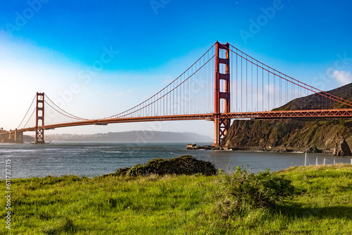 The Golden Gate Bridge over San Francisco Bay as seen from a green meadow overlook. The most famous bridge in the state of California in the USA. Bridge concept of America.