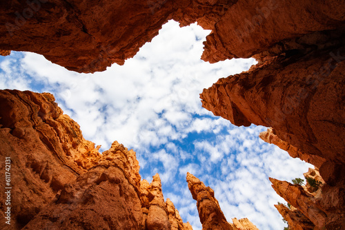 Interior of a rock structure with towers rising into the sky. Bryce Canyon National Park is an American national park located in southwestern Utah. The major feature of the park is Bryce Canyon, a col