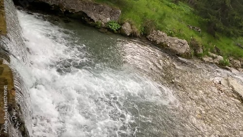 The cascade of water flowing through the forest in slow motion