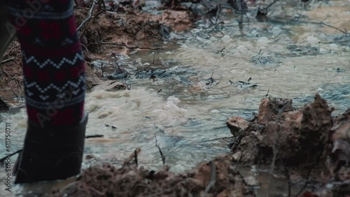 Walking through a deep puddle in rubber boots on a rainy day. Muddy forest road. High quality audio recording. ASMR style video and audio.