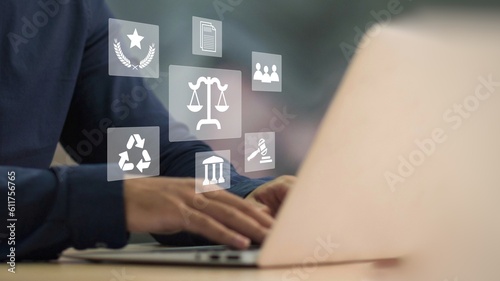 Fototapeta Naklejka Na Ścianę i Meble -  Legal business concept. Labor law, Lawyer, Online legal advice, Hand of human with legal services icon on laptop screen.