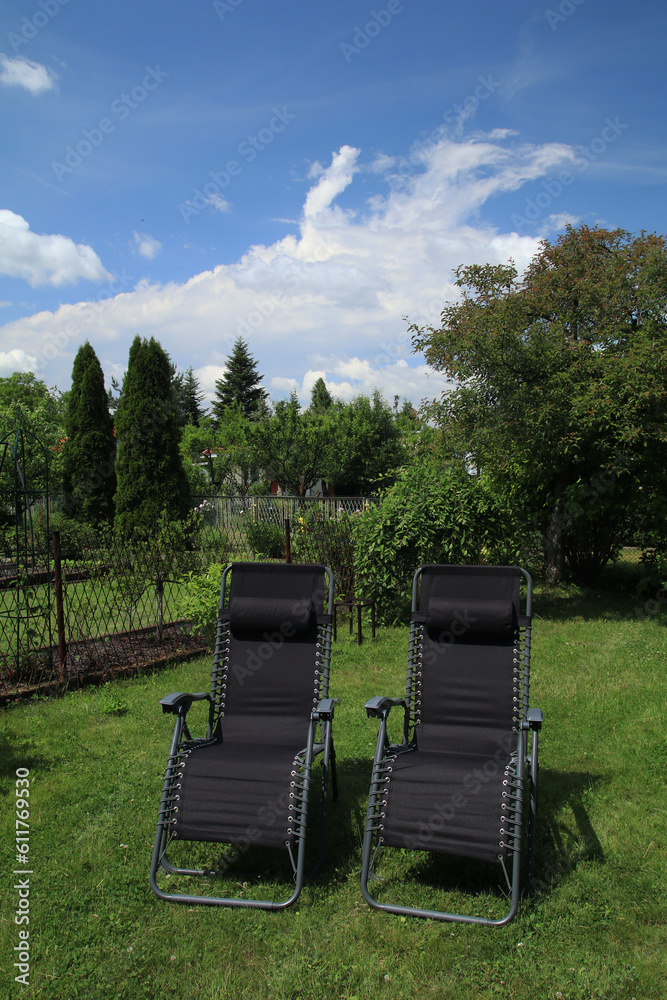 Black sun loungers in the garden
