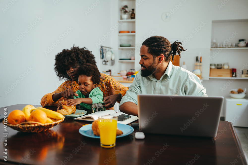 Fototapeta premium A multiracial family at the breakfast table at home in the morning.