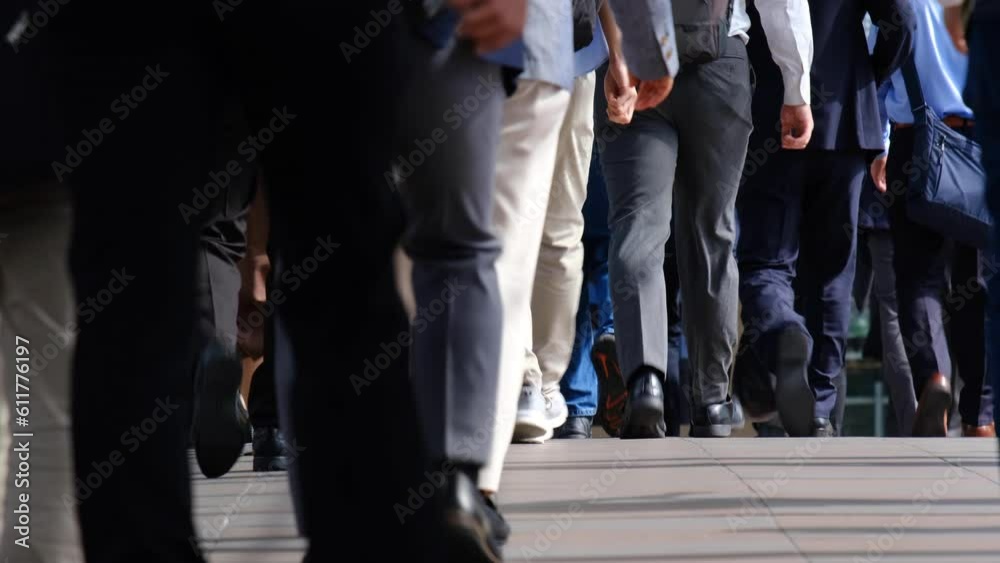 Many commuters going to work in the busy morning rush hour. Slow motion. Low angle. Many commuters going to work in the busy morning rush hour. Slow motion. Low angle.