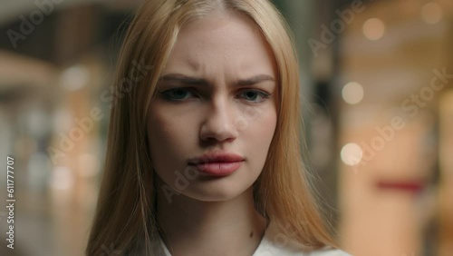 Sad angry woman head shot frowning female face upset Caucasian girl businesswoman customer client dissatisfied with service looking at camera anxiety worry facial expression close up portrait indoors photo