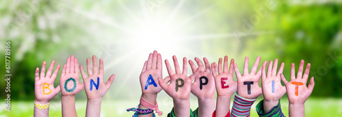 Картината върху платно Children Hands Building Word Bon Appetit, Grass Meadow