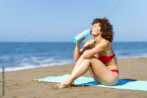 Slim woman enjoying water on seashore