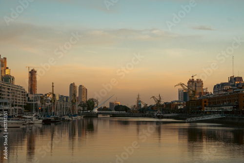 Skyscrapers on the riverside against a sunset backdrop