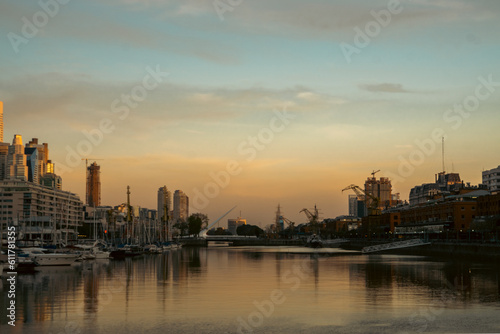 Skyscrapers on the riverside against a sunset backdrop