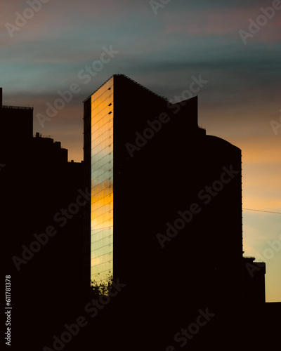 A silhouette of skyscrapers against a sunset backdrop