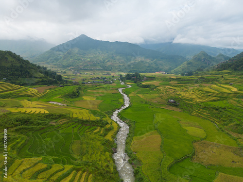 Aerial top view of fresh paddy rice terraces, green agricultural fields in countryside or rural area of Mu Cang Chai, mountain hills valley in Asia, Vietnam. Nature landscape background.