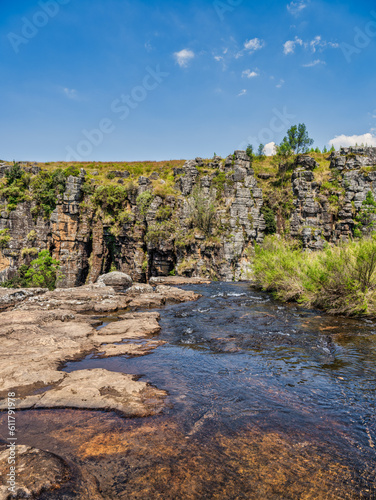 Vertical shot of Ngwaritsana river flowing before it drops over the mountain at the Driekop Gorge with blue sky, Mpumalanga, South Africa