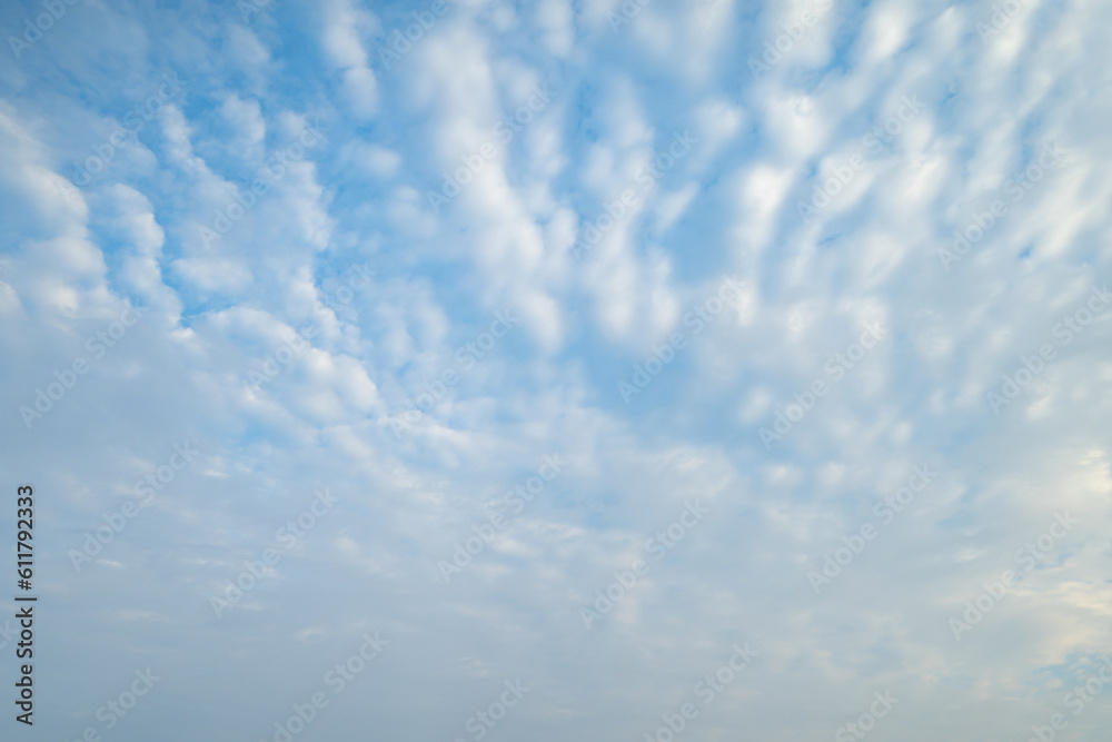 Clear blue sky with white fluffy clouds at noon. Day time. Abstract nature landscape background.