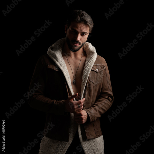 attractive shirtless man wearing wool cardigan and jacket and posing