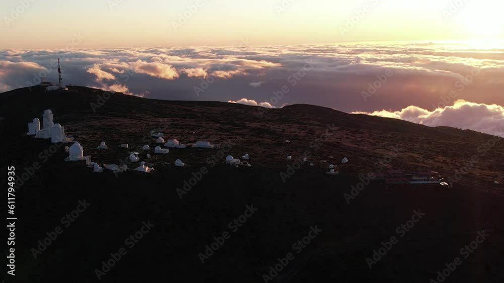 Early morning sunrise above the Teide Volcano in Tenerife in the Canary Islands by the Telescopes at the Observatory Early morning sunrise above the Teide Volcano in Tenerife in the Canary Islands by the Telescopes at the Observatory