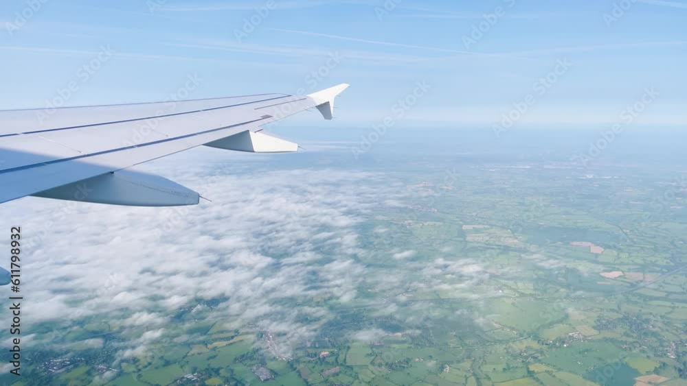 Airplane flight. Wing of an airplane flying above the clouds with sunset sky. View from the window of the plane. Airplane, Aircraft. Traveling by air. 4K UHD video Airplane flight. Wing of an airplane flying above the clouds with sunset sky. View from the window of the plane. Airplane, Aircraft. Traveling by air. 4K UHD video