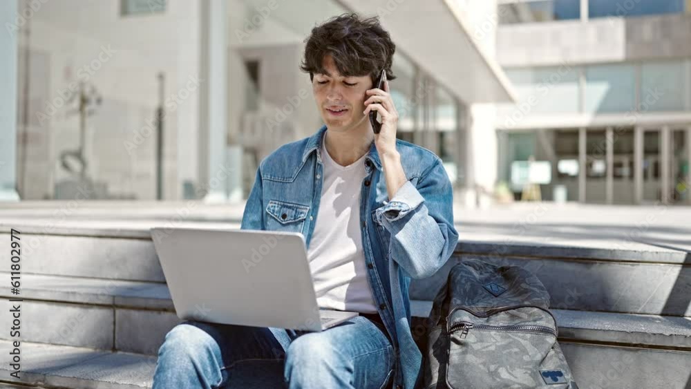 Young hispanic man student using laptop talking on smartphone at university Young hispanic man student using laptop talking on smartphone at university