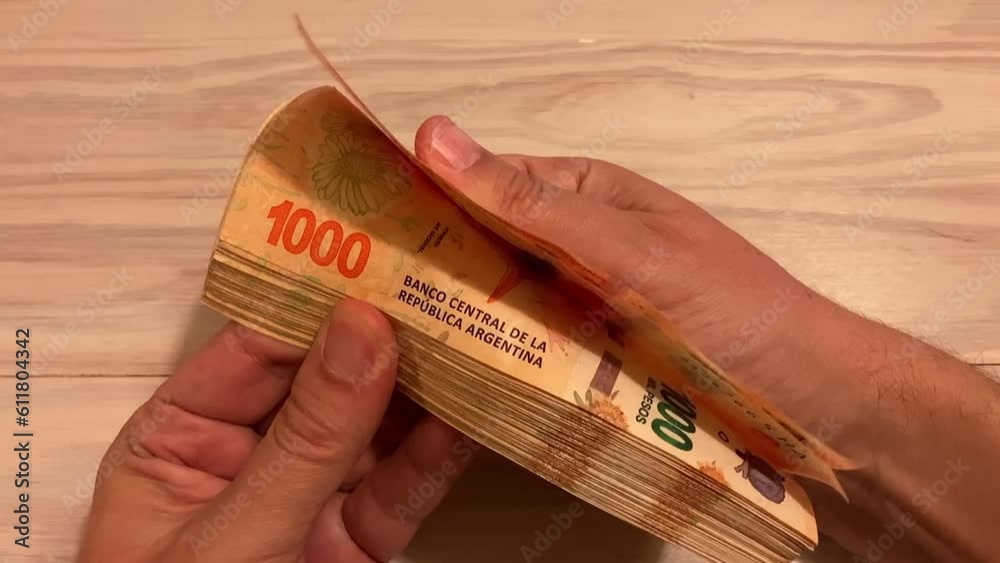 slow motion of hands counting money Argentine 1000 peso bills, symbol for Argentina's inflation