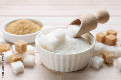 Different types of sugar on white wooden table, closeup