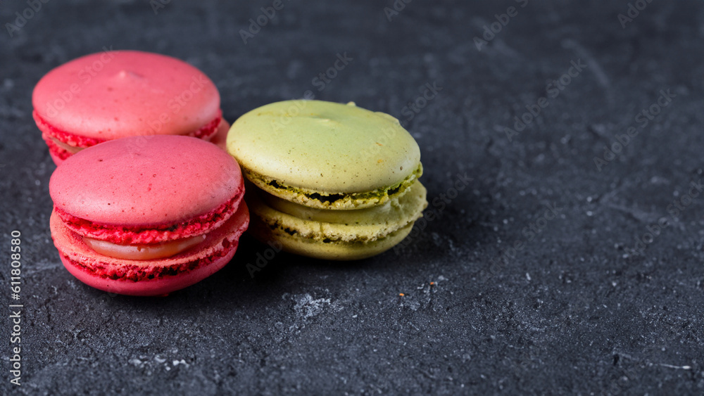 Sweet and colourful french macaroons or macaron on dark background, Dessert - generative ai