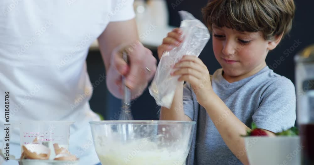 Baking, ingredients and father with child in kitchen learning cooking skills, child development and helping. Home, family and dad with son mixing flour for cake, baked food and whisk for breakfast Baking, ingredients and father with child in kitchen learning cooking skills, child development and helping. Home, family and dad with son mixing flour for cake, baked food and whisk for breakfast