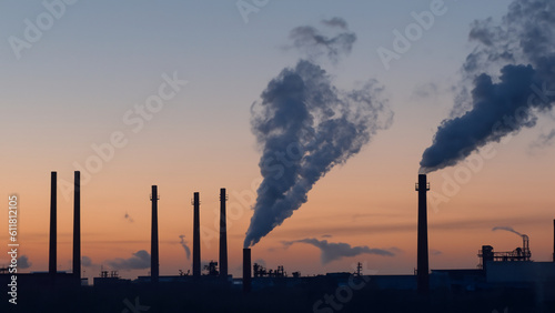 Smoke from the chimneys of a metallurgical plant at dawn. - generative ai
