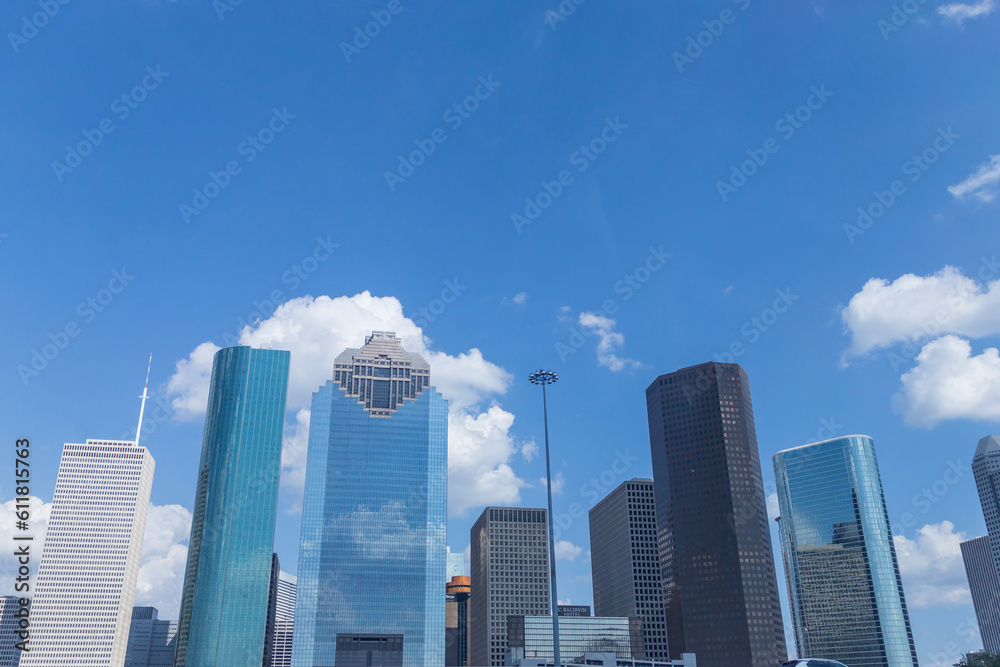 photo of the Houston downtown skyline with clouds in the background.