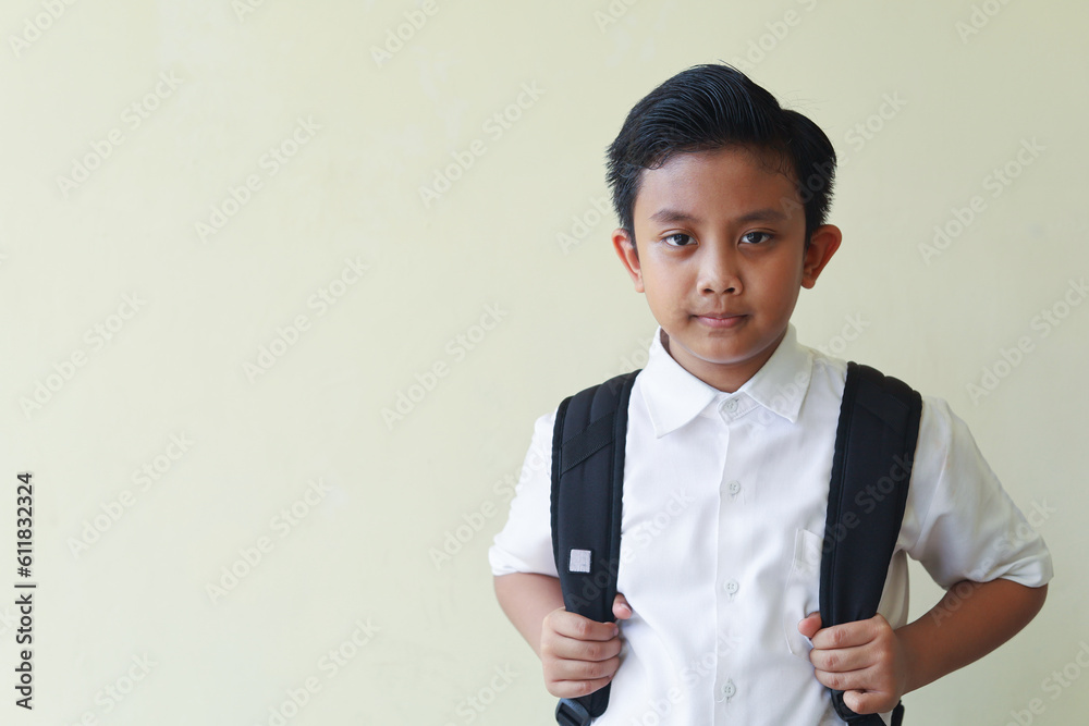 Portrait of a young handsome kid boy wearing school uniform, concept of ready and happy back to school. Portrait of a young handsome kid boy wearing school uniform, concept of ready and happy back to school.