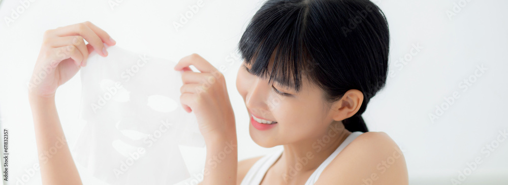 Beautiful young asian woman holding sheet facial mask for skin care and treatment, beauty girl showing sheet face mask with fun and relax at home, skincare and therapy for smooth, health and wellness. Beautiful young asian woman holding sheet facial mask for skin care and treatment, beauty girl showing sheet face mask with fun and relax at home, skincare and therapy for smooth, health and wellness.