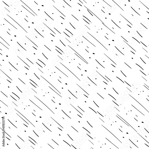 The rain falls obliquely, dragging the dots with it