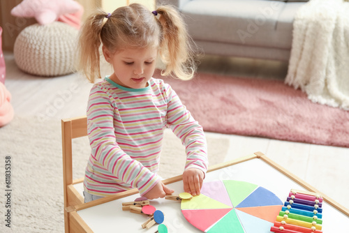 Cute little girl playing ma...