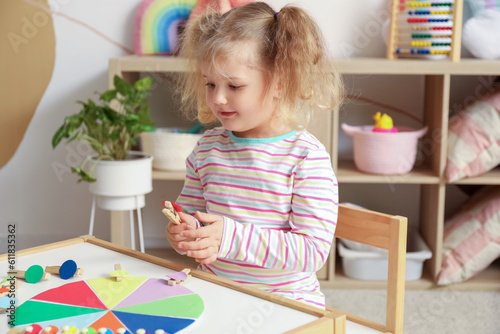 Cute little girl playing ma...