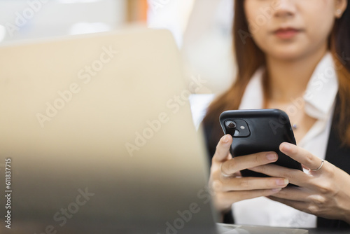 Close up mobile phone. asian attractive female business using smartphone sitting office. Space for message design. businesswoman online working with cellphone.