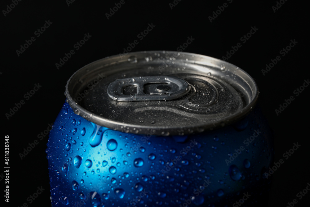 Blue can of fresh soda with water drops on dark background, closeup Blue can of fresh soda with water drops on dark background, closeup
