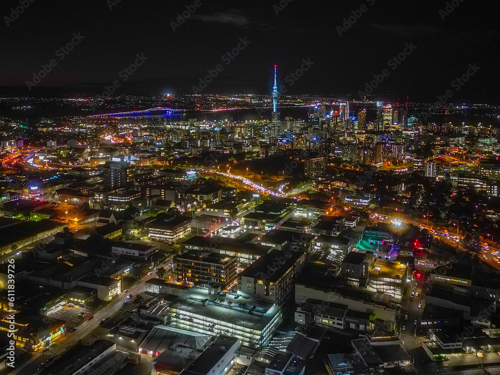 Auckland Skyline at Night. Aerial view of the downtown landmarks, Sky Tower, Harbour Bridge, highways and CBD shinning bright. Auckland Skyline at Night. Aerial view of the downtown landmarks, Sky Tower, Harbour Bridge, highways and CBD shinning bright.